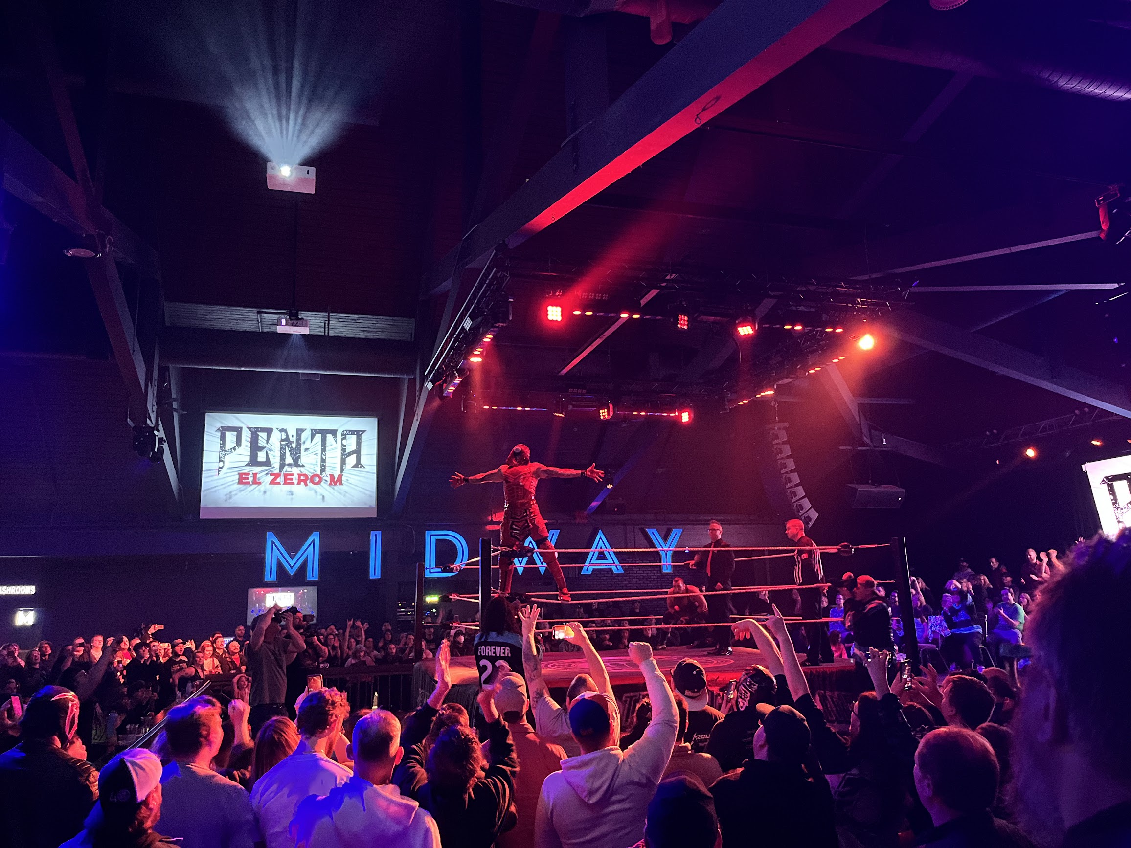 Live professional wrestling show in Edmonton Alberta — crowd watching AEW wrestlers