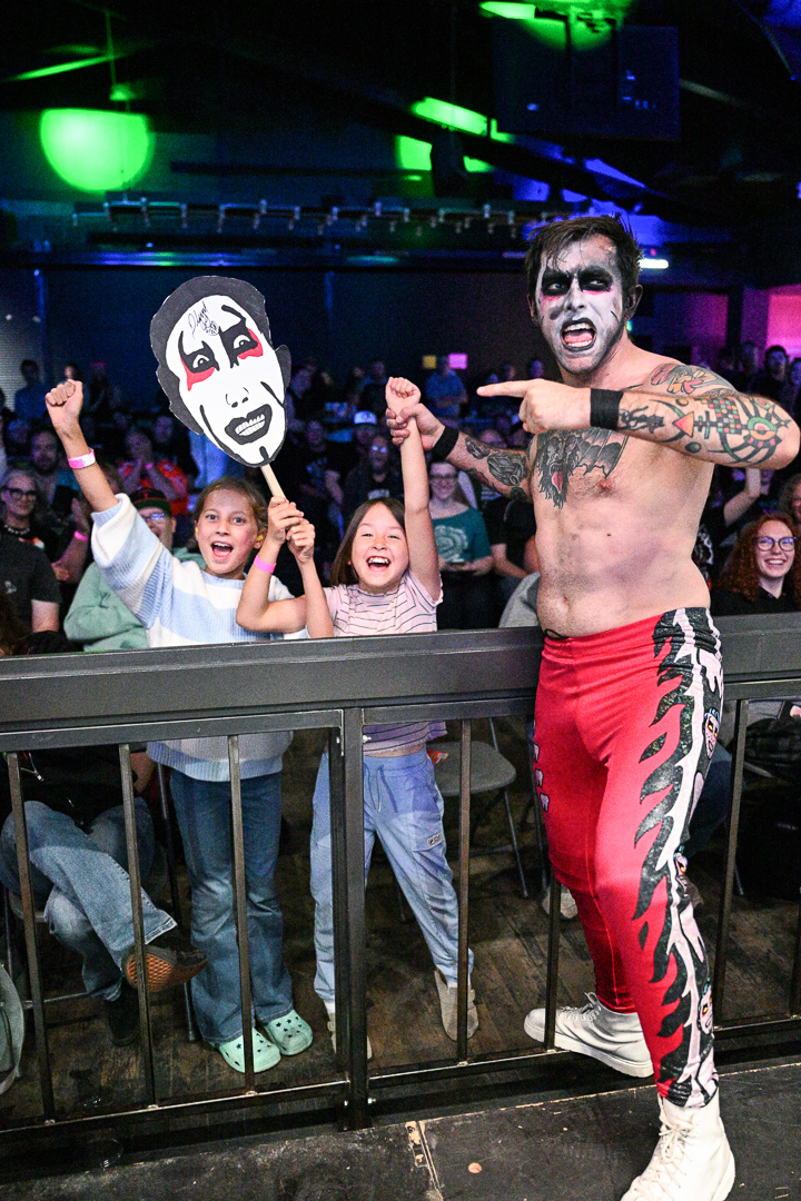Professional wrestler with excited young fans at Top Talent Wrestling event in Edmonton Alberta