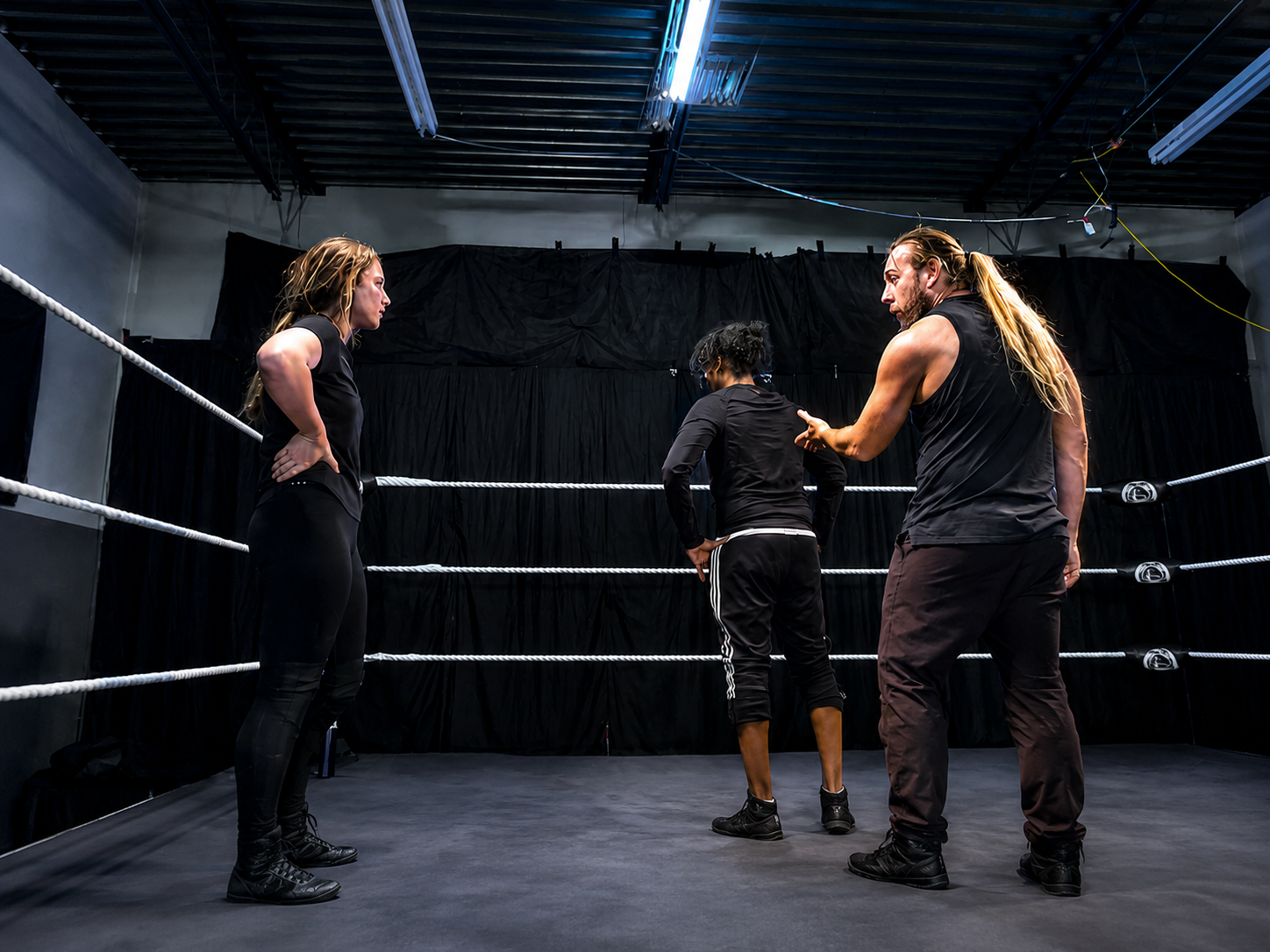 Wrestling coach training students in the ring at Top Talent Wrestling Academy Edmonton Alberta